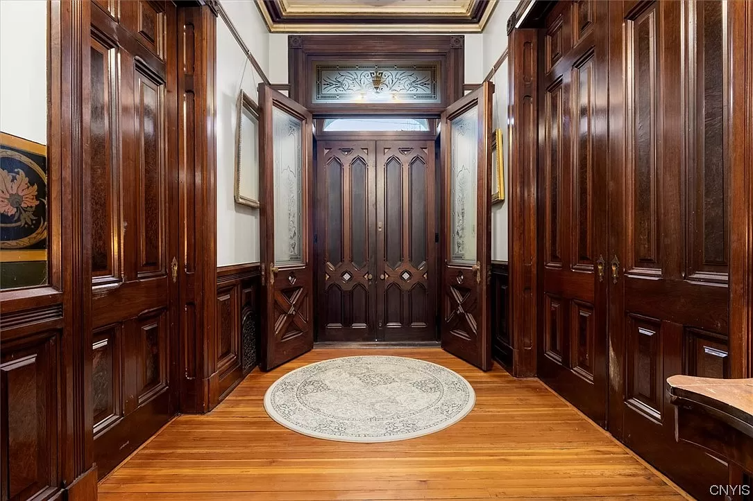 entrance with original wood moldings and doors and glass doors in the vestibule