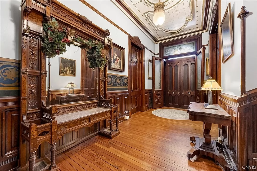 entrance with ornamental painting on ceiling, wainscoting and wood floor