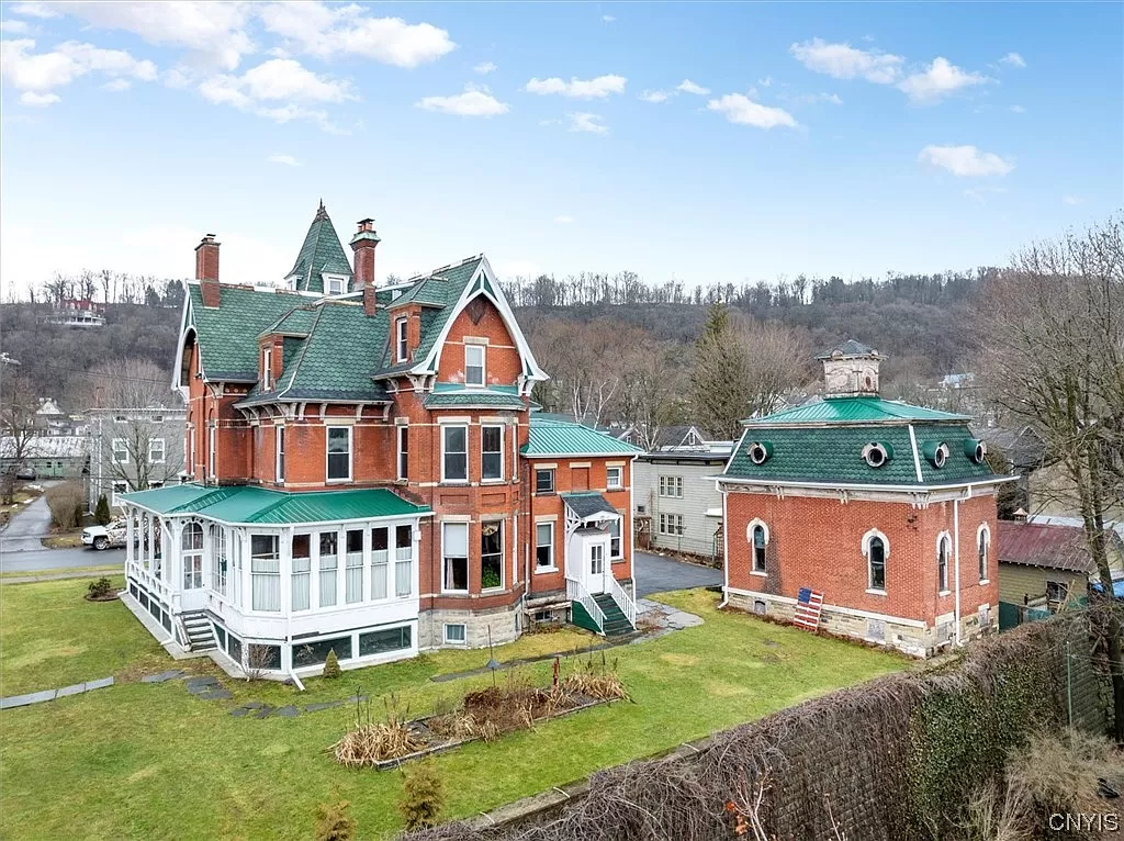 house and carriage house with view of yard