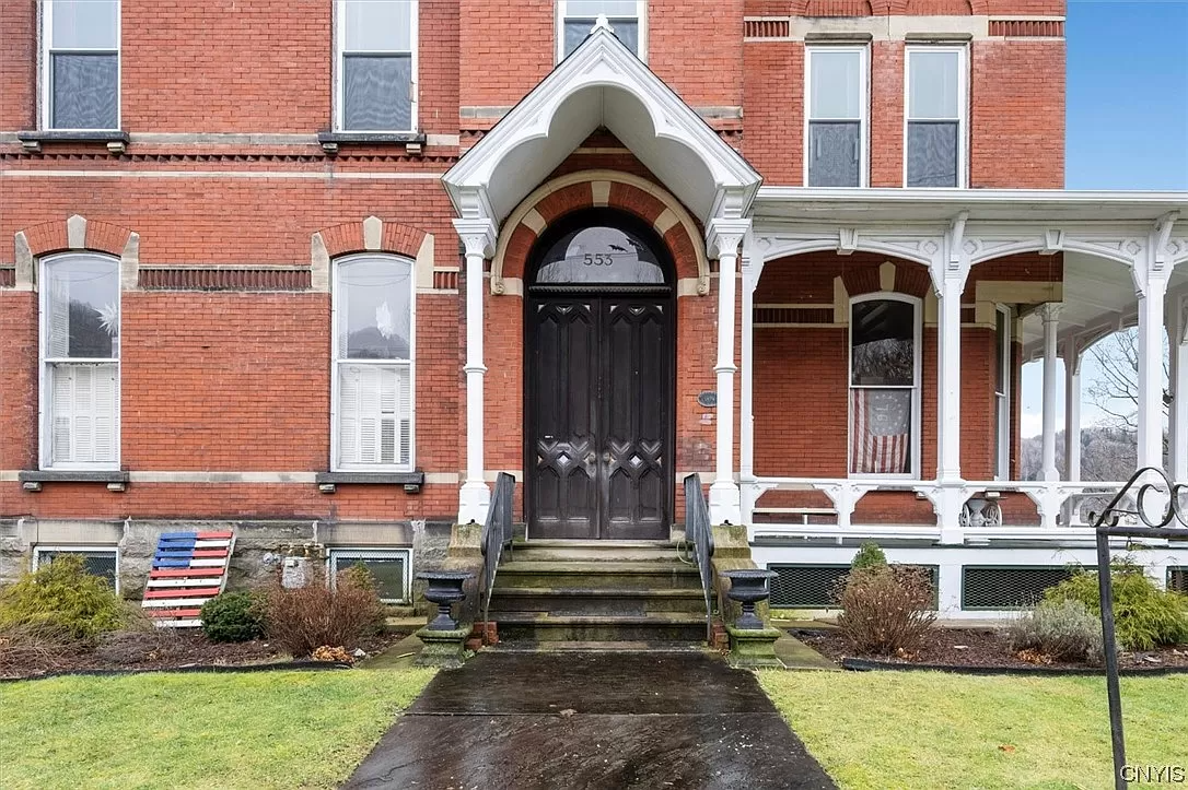 front entrance with door surround and porch painted white