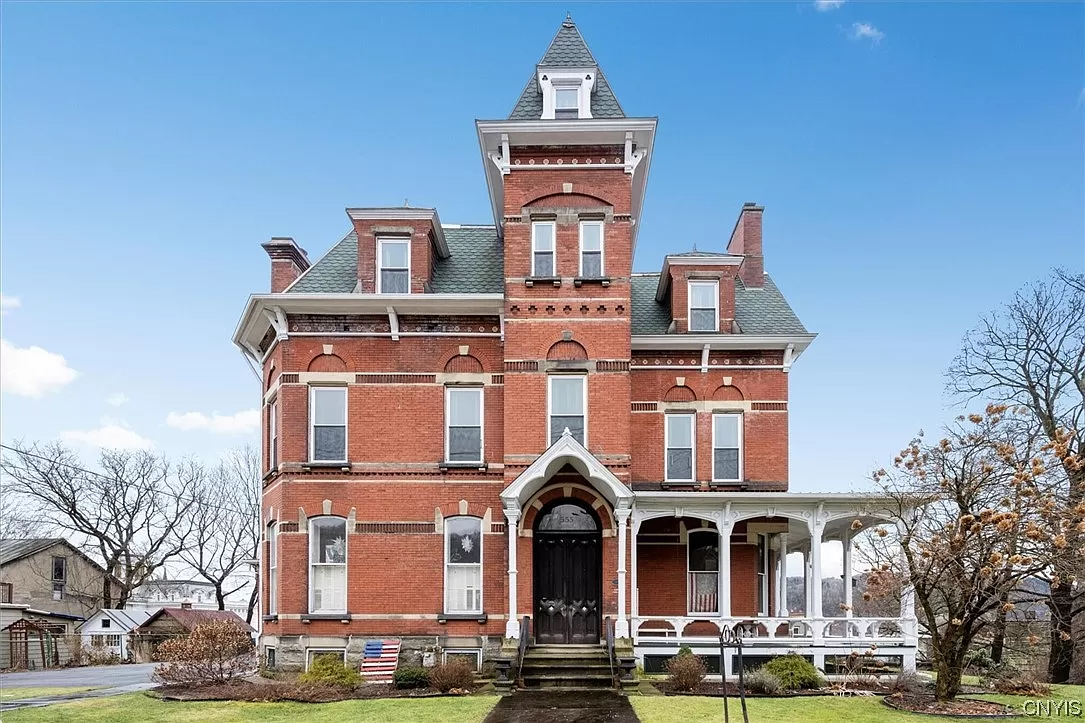 upstate house - brick second empire style house with a tower and porch