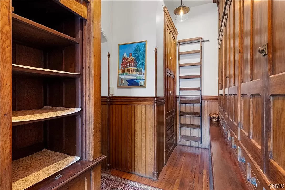 butler's pantry with original storage and wood wainscoting