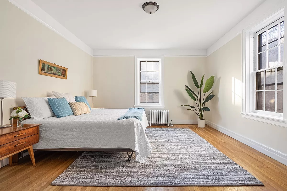 bedroom with two exposures and wood floor