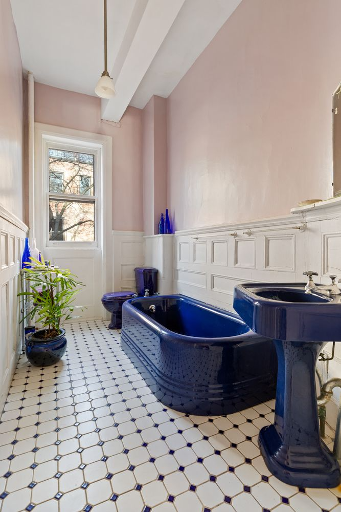 bathroom with blue fixtures and white wainscoting