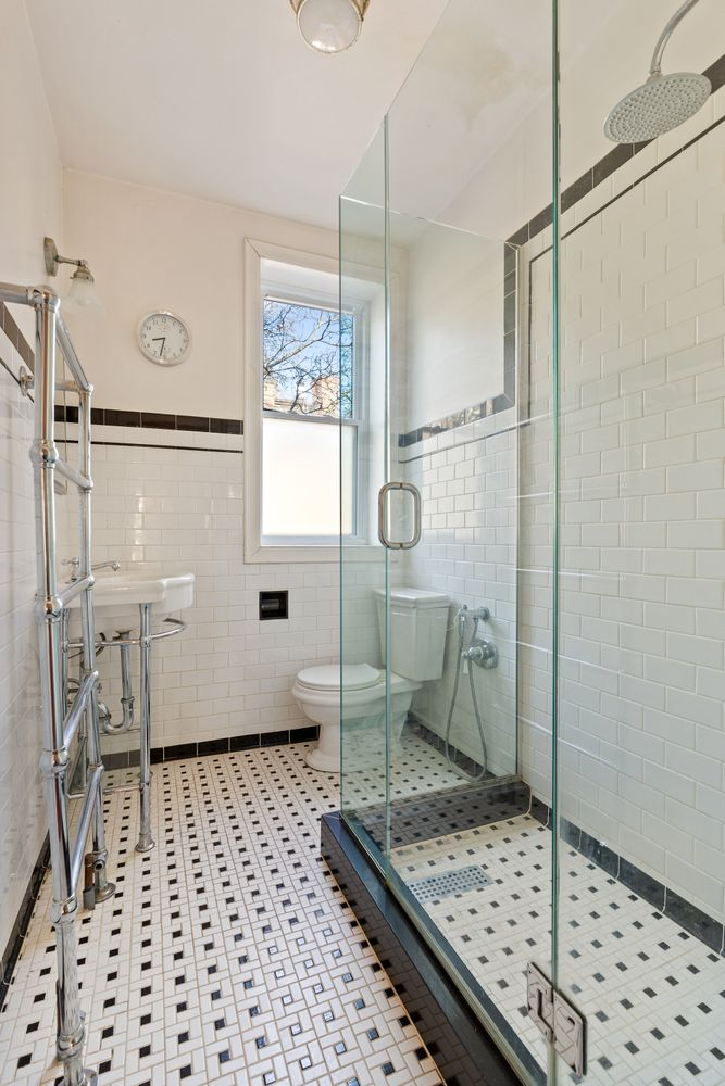 bathroom with glass shower and black and white tile floor