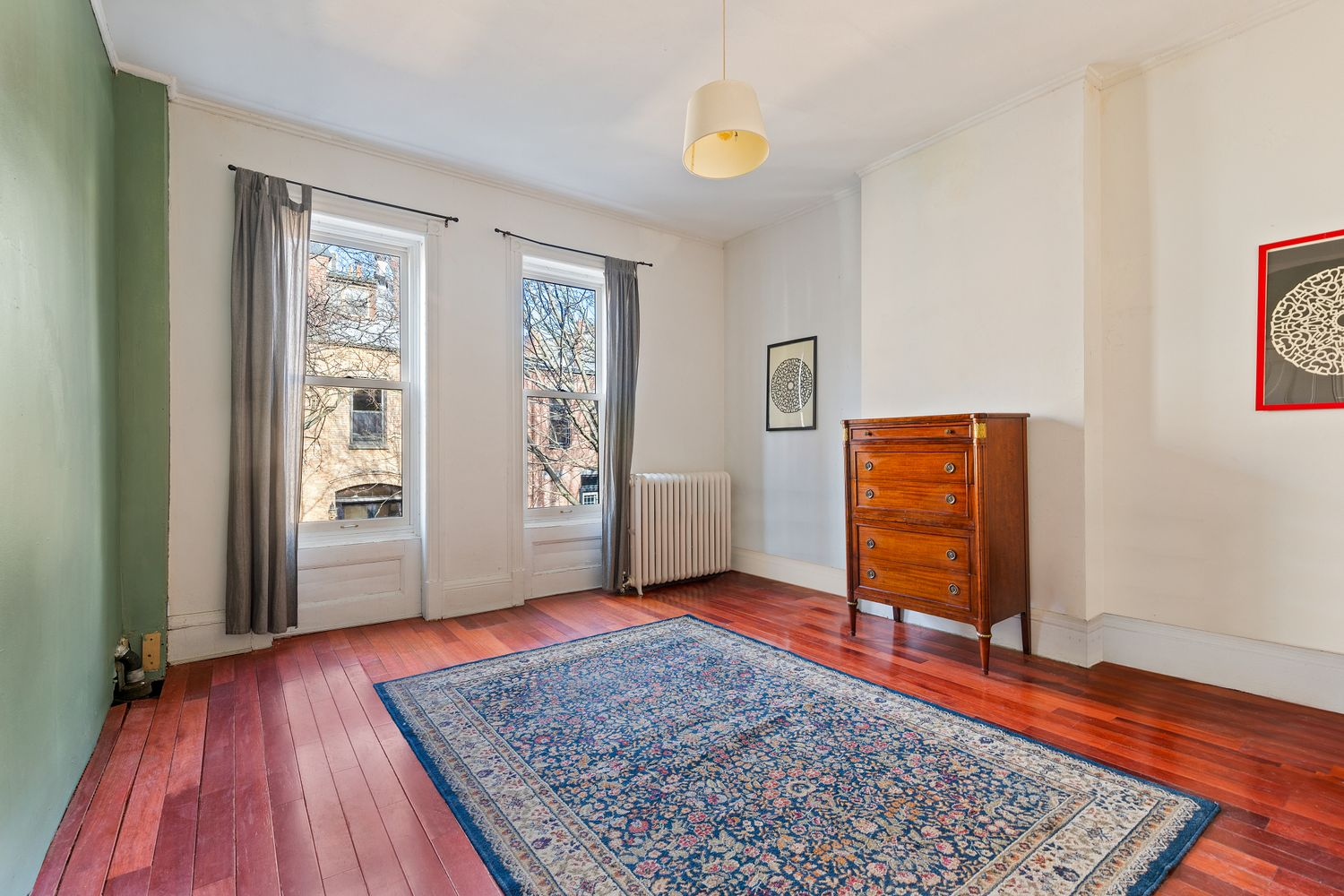 bedroom with wood floor and two windows