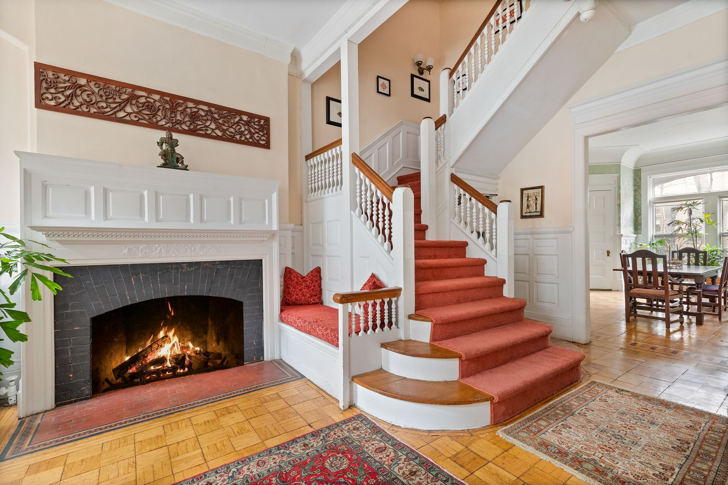 entry with fireplace and a built-in bench with white painted woodwork