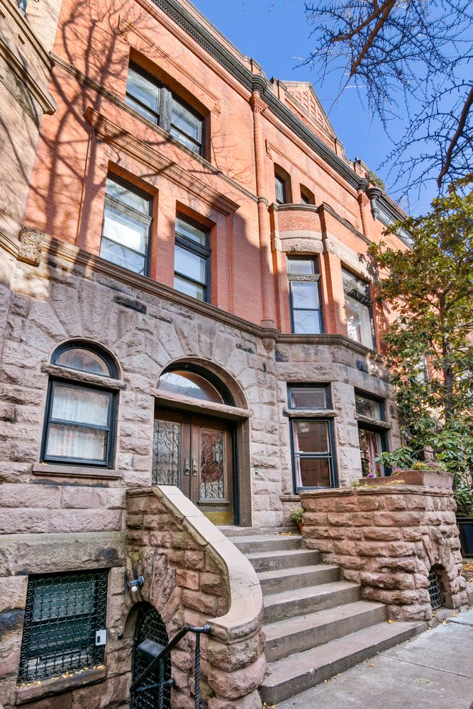 exterior with rough faced brownstone base and red brick above