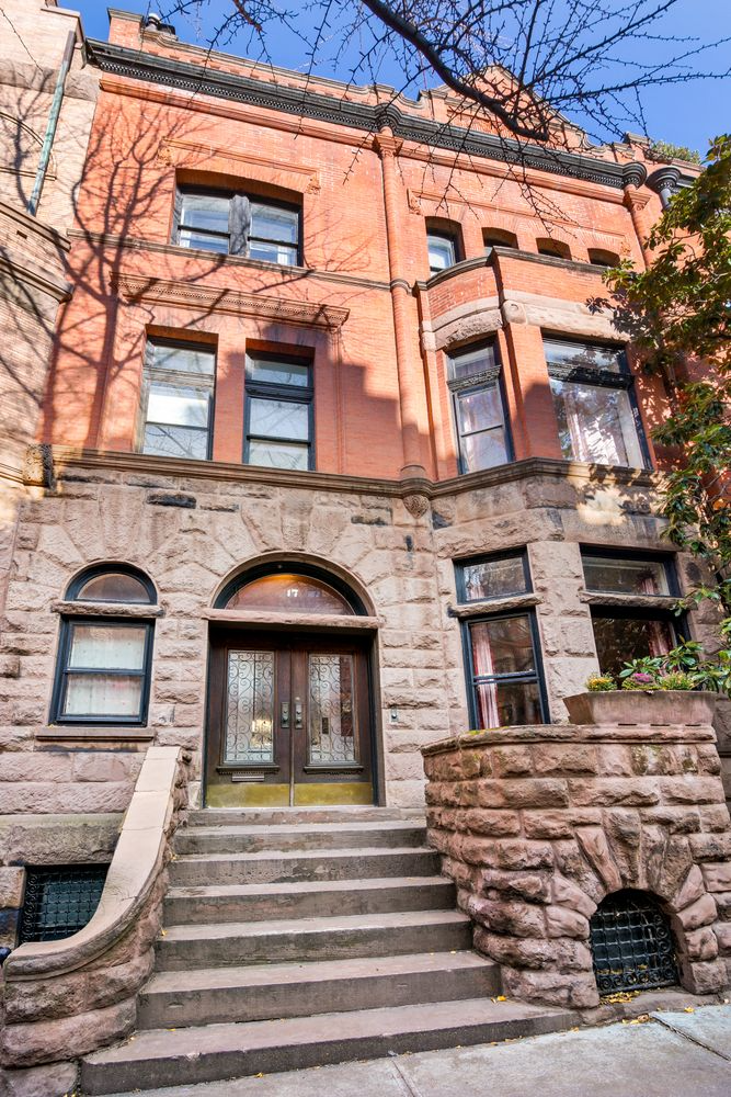 exterior with rough faced brownstone base and red brick above