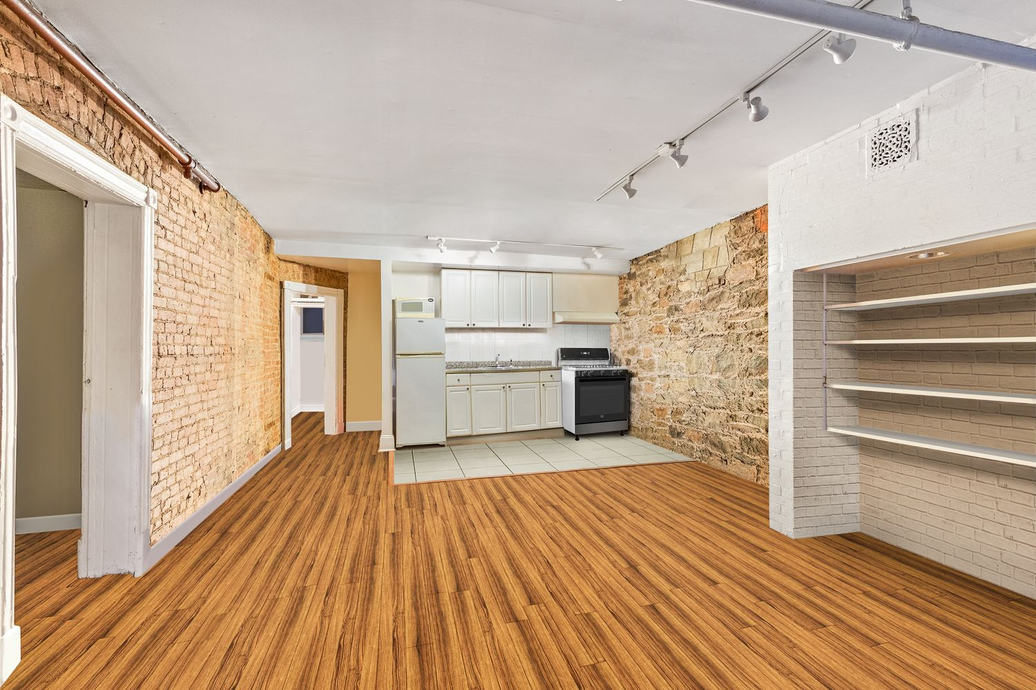 garden level with exposed brick walls and a small kitchen