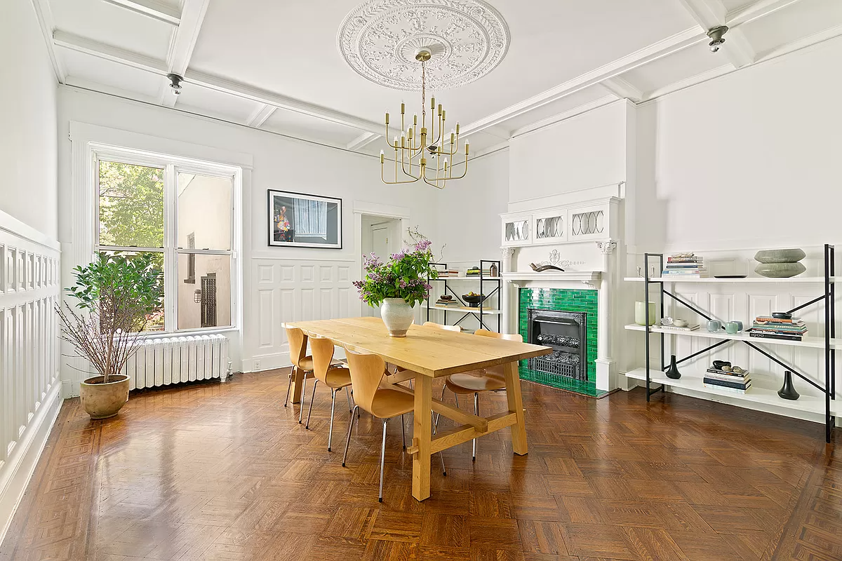 brooklyn open house - dining room with white woodwork and mantel with green tile