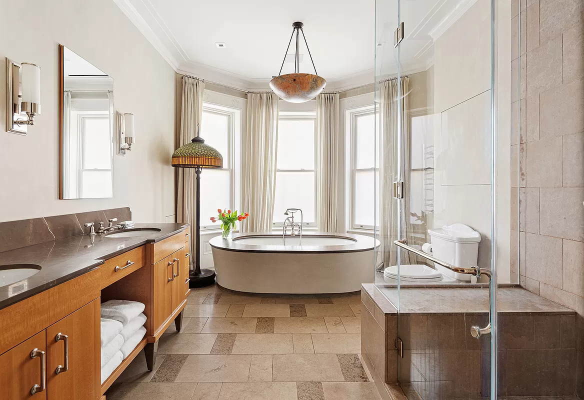 bathroom with a soaking tub and a separate glass shower