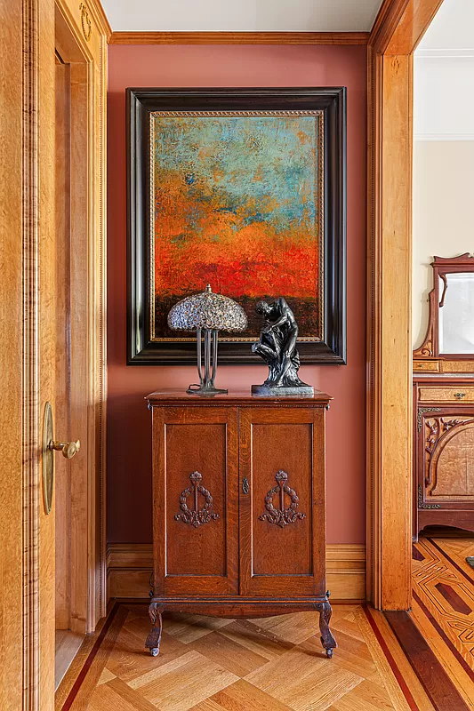 detail of original wood floors with inlaid border and the door moldings