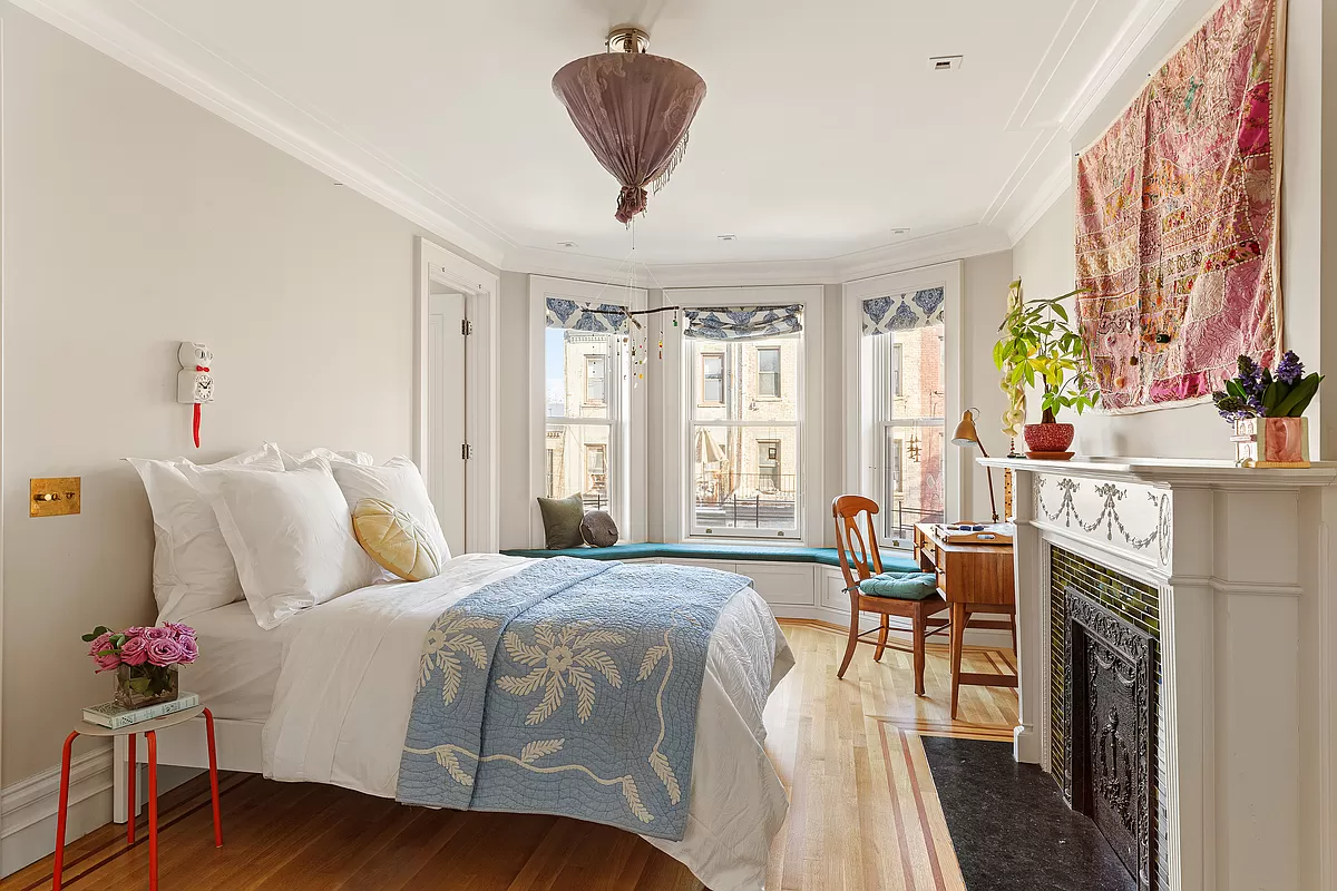 bedroom with window seat with blue cushion