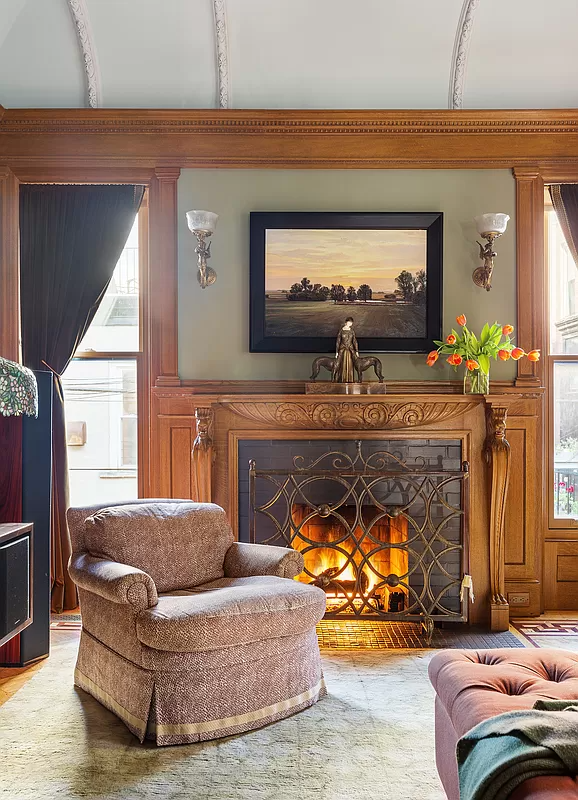 living room with wainscoting and a fireplace