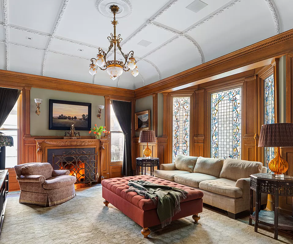 living room with stained glass windows and a fireplace