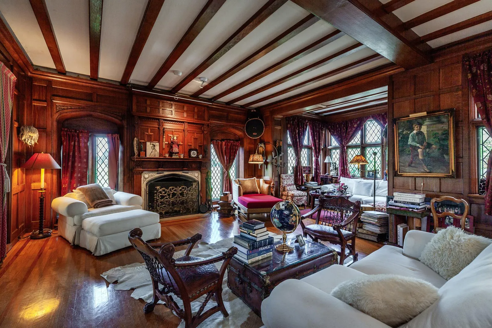 parlor with beamed ceiling and wood paneling