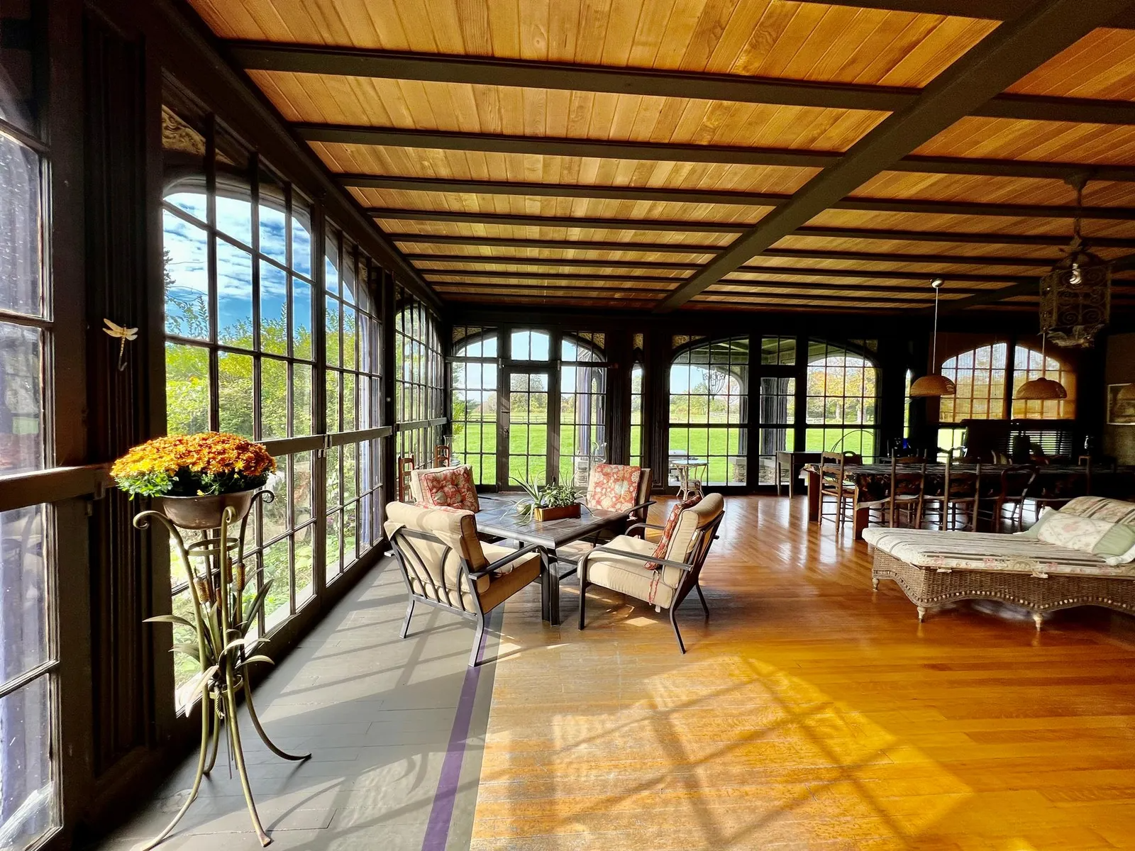 large sunroom with wood floor and ceiling