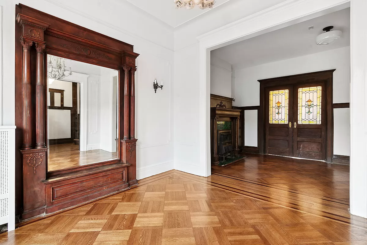 pier mirror in a front parlor with view to middle parlor with mantel