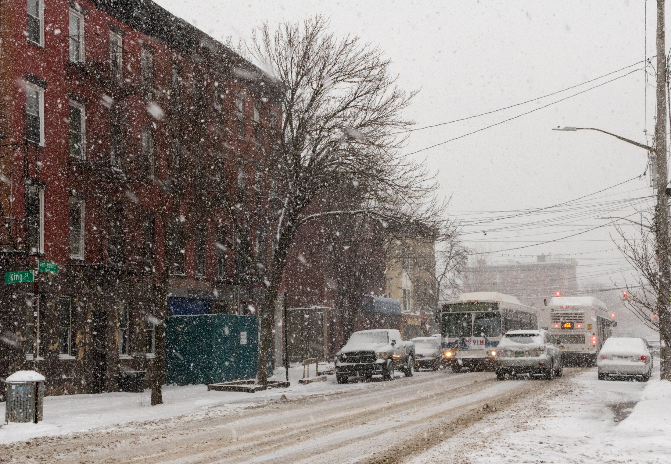 snowy view of buses on van brunt street in brooklyn