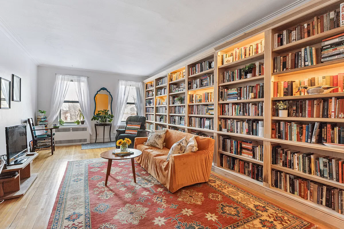 windsor terrace - living room with wood floor and a wall of bookshelves