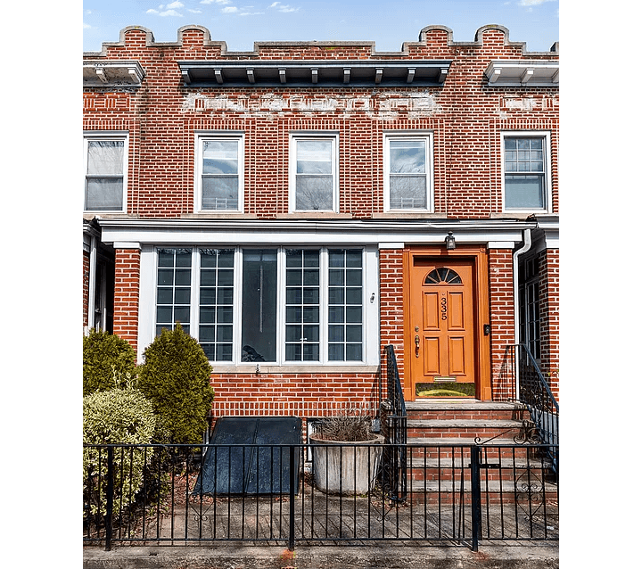 brick row house with enclosed porch