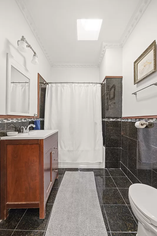 bathroom with black floor and wall tile