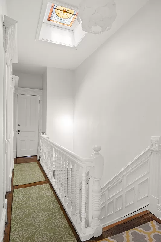 upstairs hallway with stained glass skylight