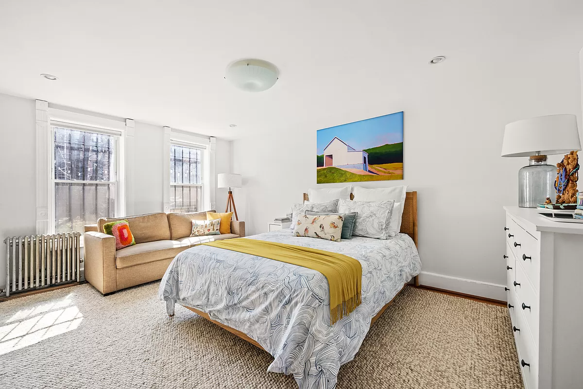 bedroom on the garden level with recessed lighting and white walls