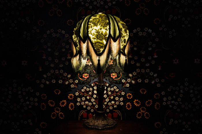a glowing lamp with a green floral shade
