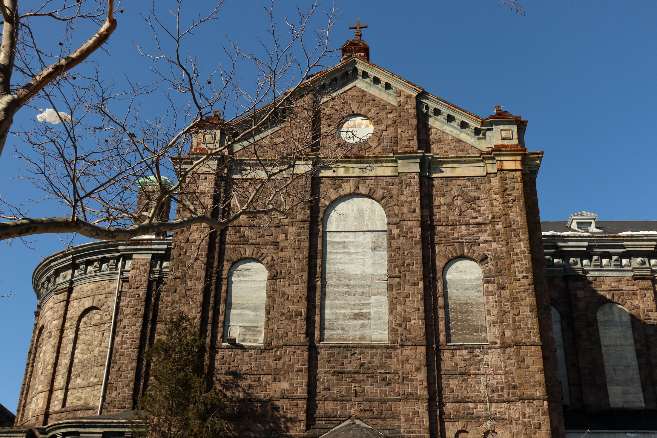 stone church with boarded up windows