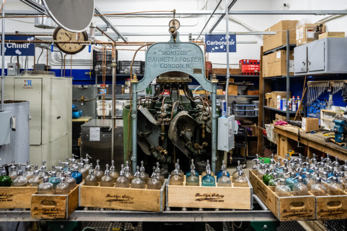 seltzer bottles on the assembly line