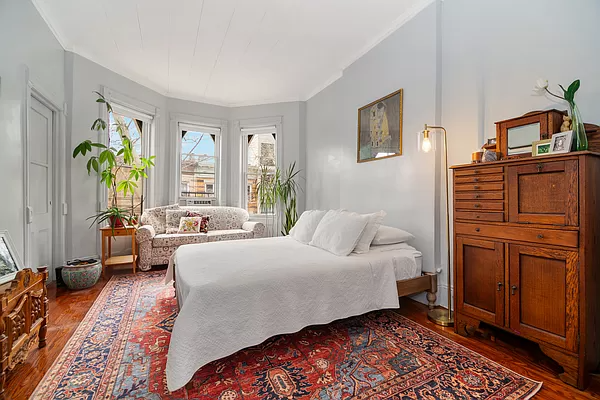 bedroom with wood floor and bay window