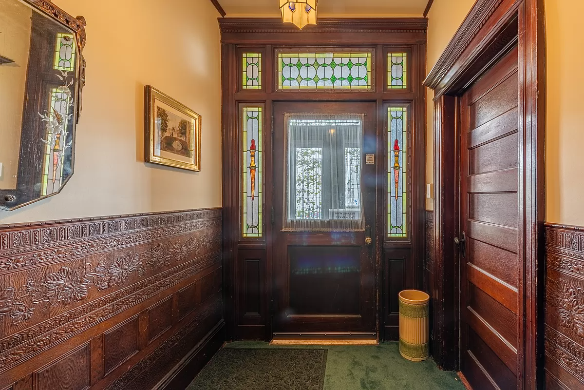 entry to building with stained glass,wainscoting and wood moldings