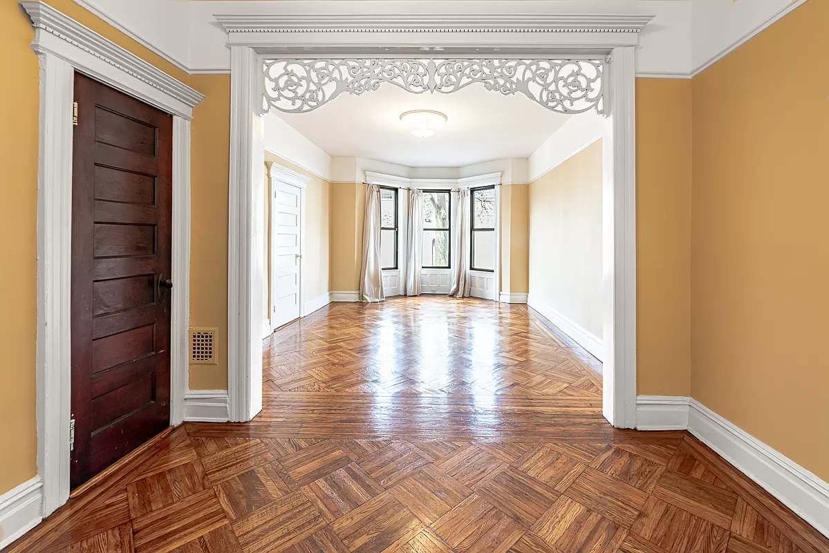 bushwick - living room with fretwork, moldings and wood floor