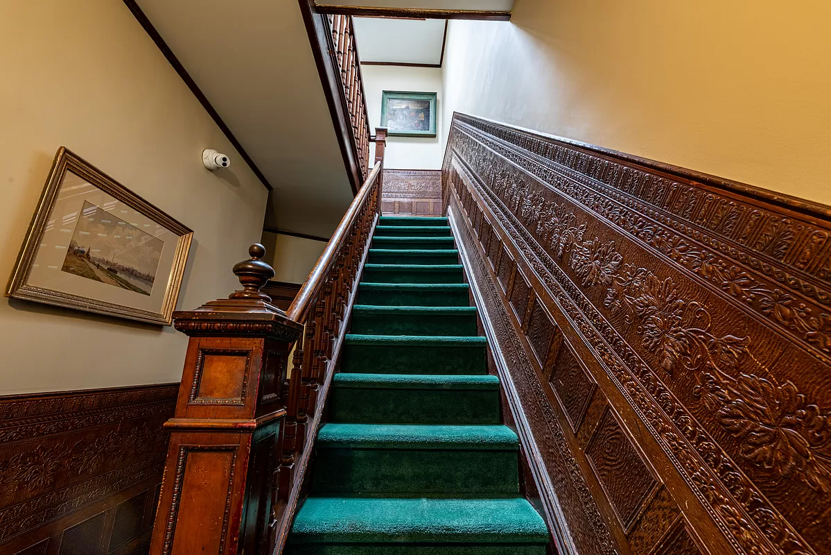 staircase with green carpet