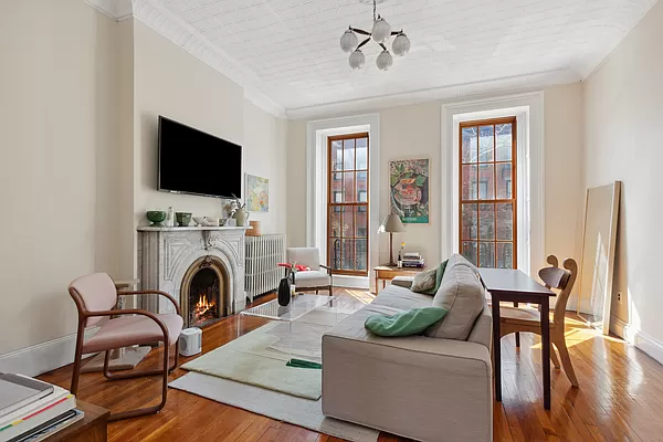 parlor with a marble mantel and tin ceiling