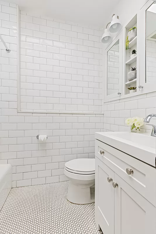 bathroom with white subway tile and white fixtures