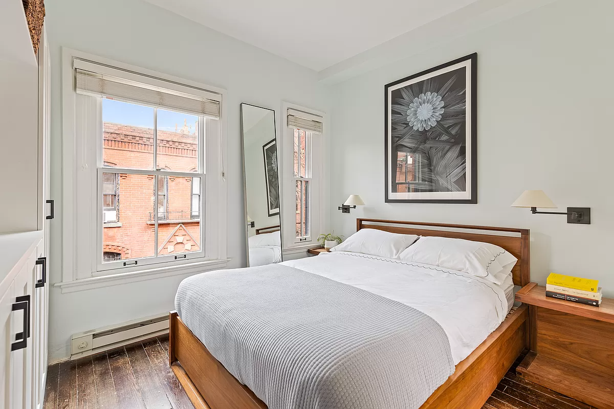 bedroom with two windows and wood floor