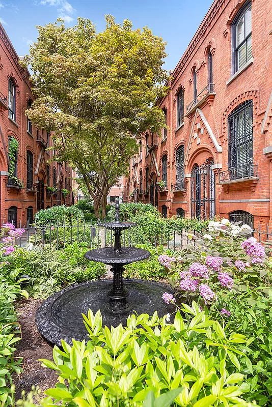 view of mews with a fountain and greenery