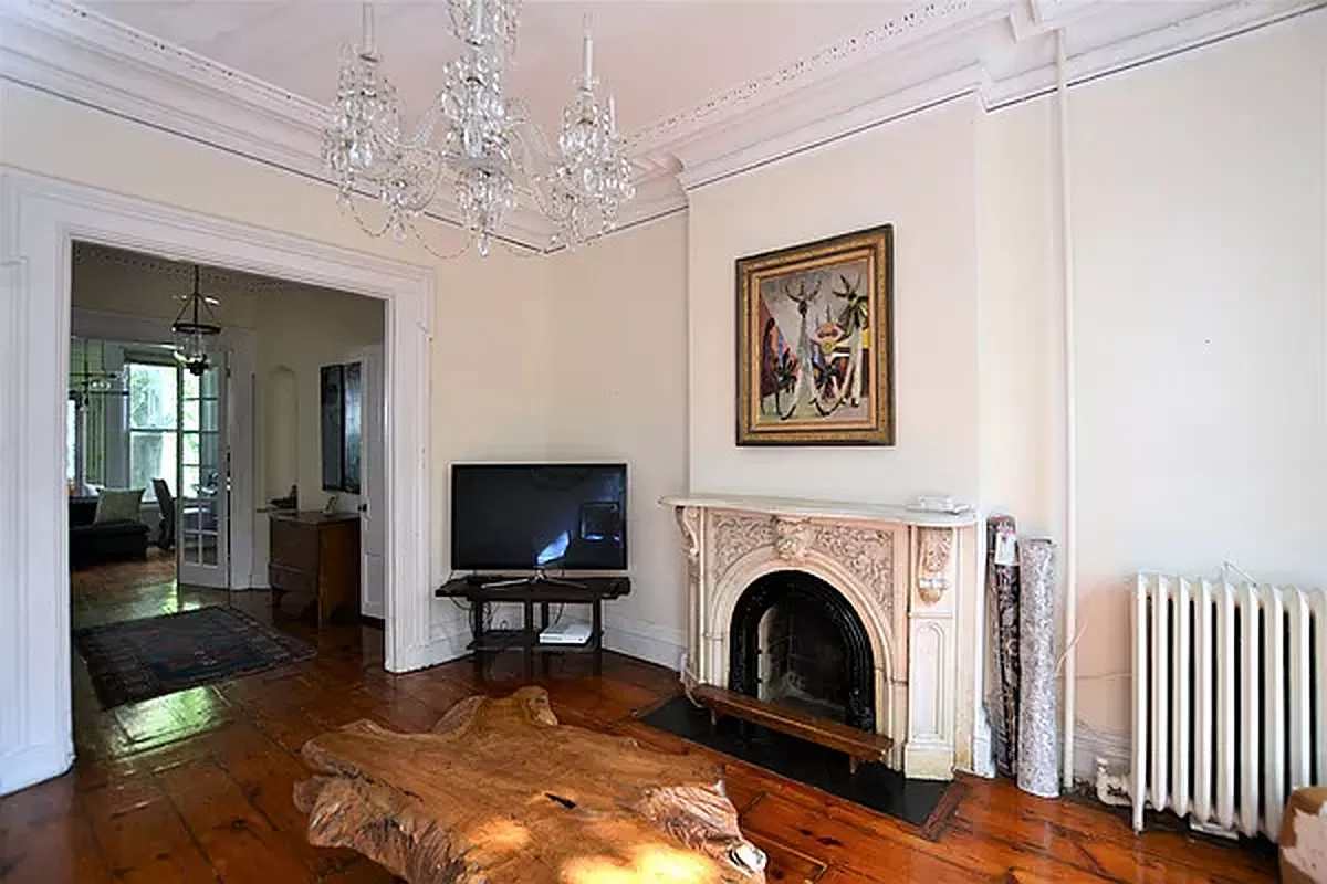 parlor with plaster details and a marble mantel