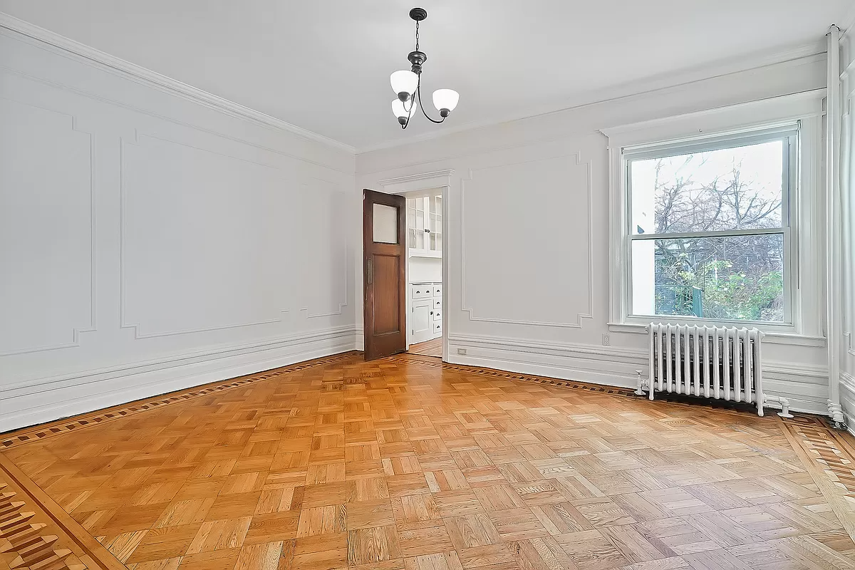 dining room with wall moldings and door to kitchen