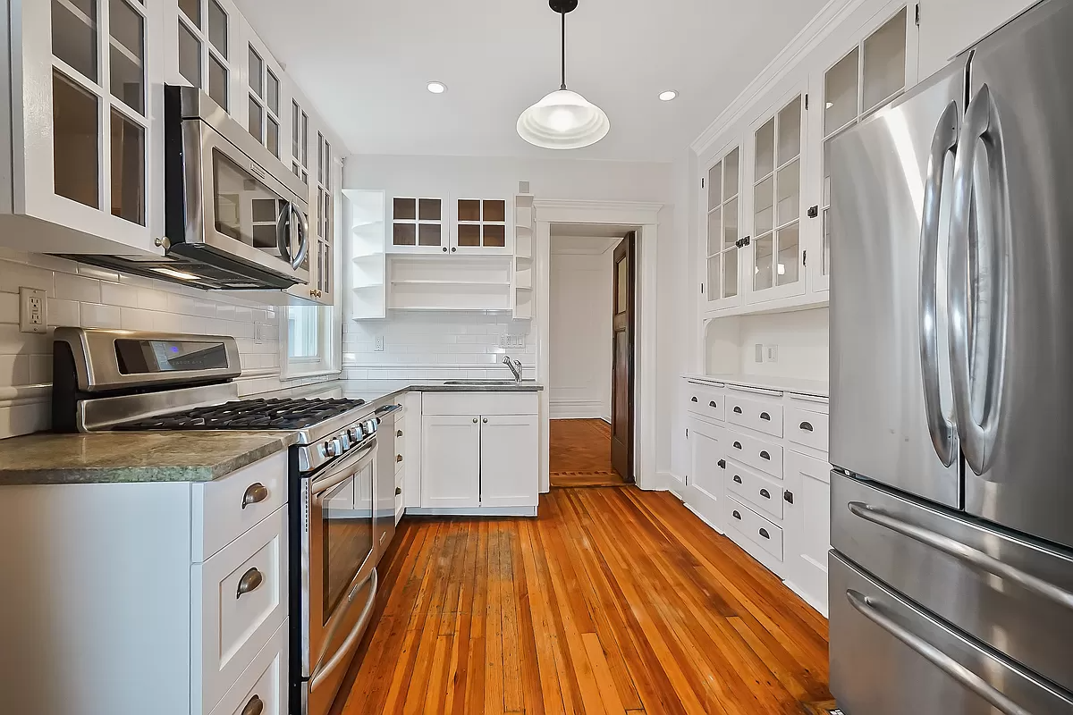 kitchen with white cabinets and wood floor