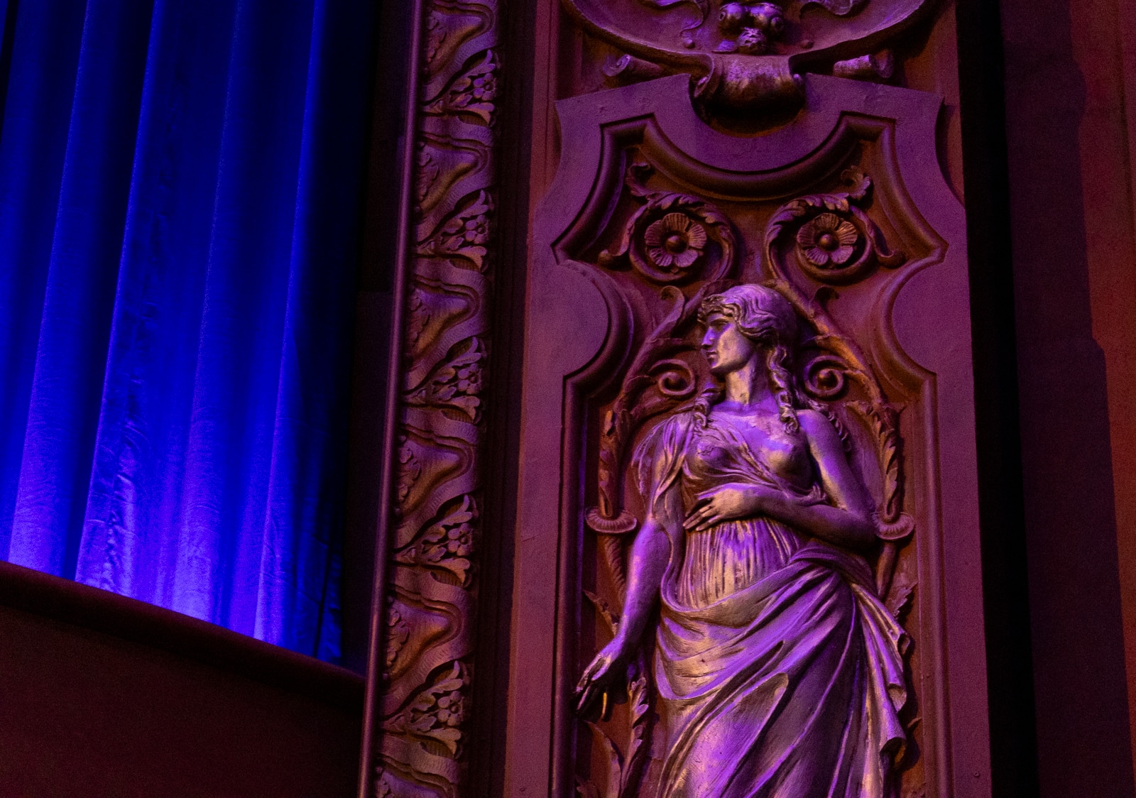 the figure of a woman amidst the ornamental details in the main auditorium