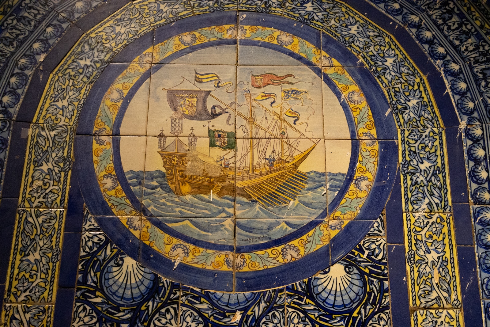 blue and yellow tiles with a ship in the center panel