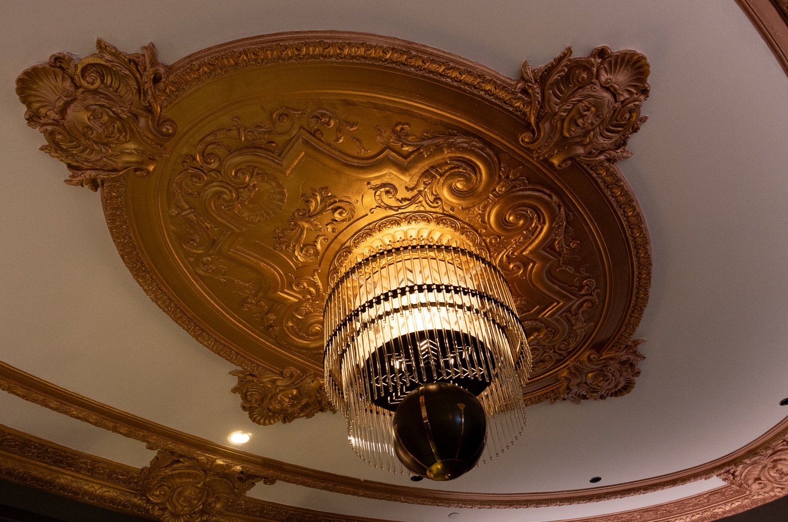 a ceiling medallion and chandelier in the bar area