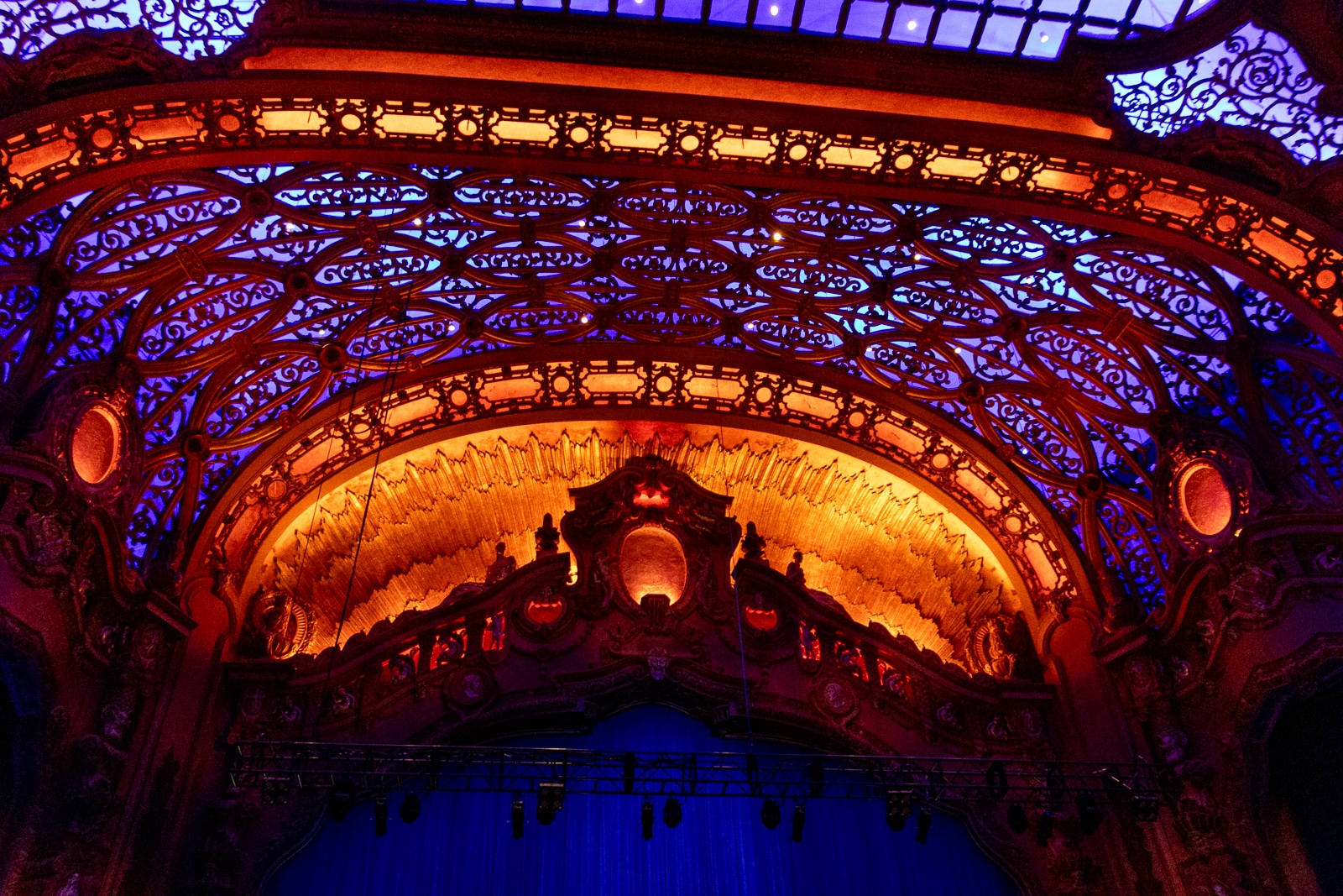 the auditorium lit in purples, pinks, and oranges