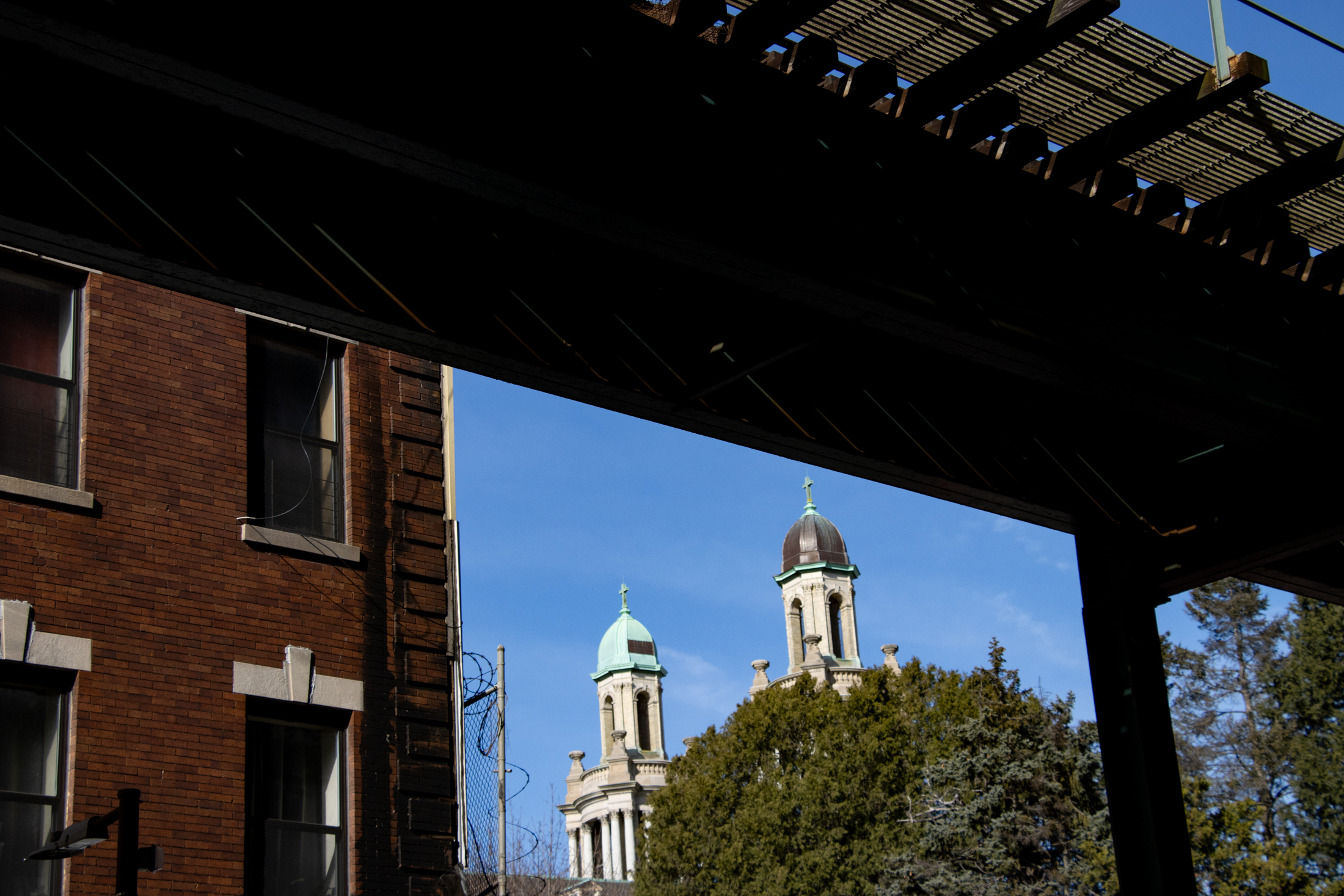 brooklyn - elevated tracks in east new york with glimpse of church towers