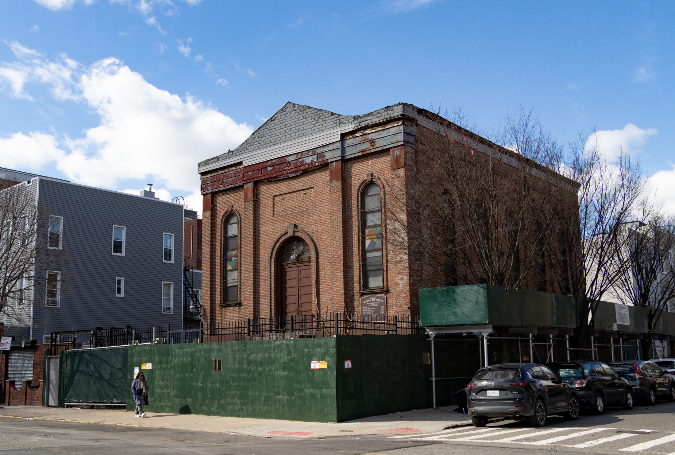 brick church and former synagogue behind a construction fence