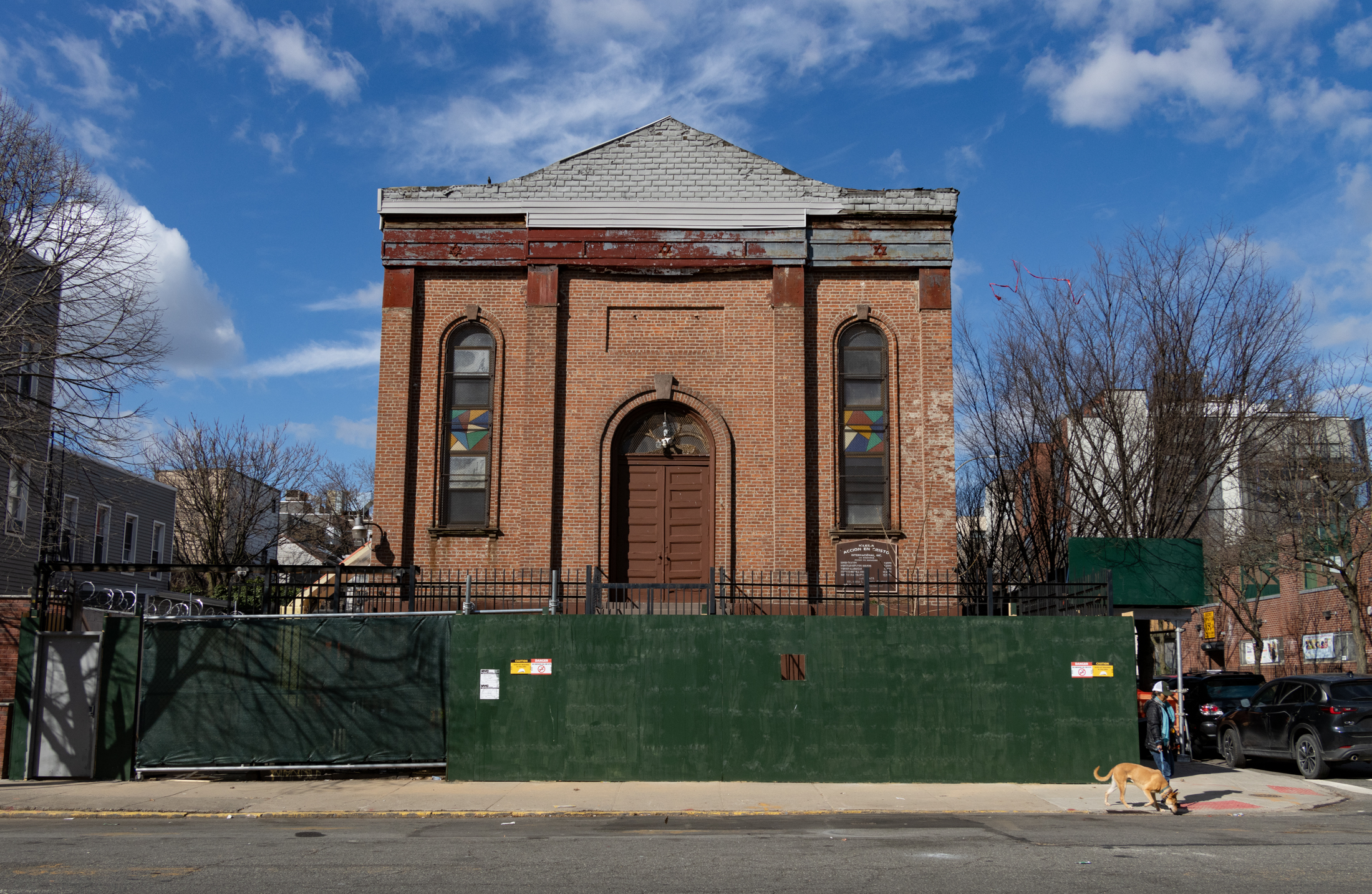 brick church and former synagogue behind a construction fence